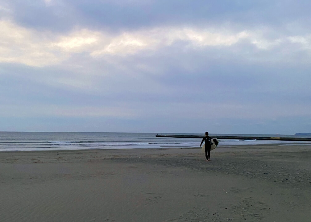 Jon Omori, advisor to the City of Makinohara, heading into Shizunami Bay for sunrise surf.