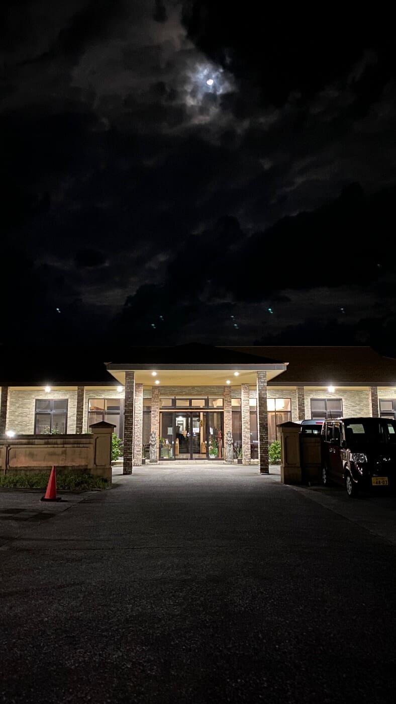 Hachijojima guide to hotels at night, with a bright moon, offering a welcoming sight after a wild trip on the island.