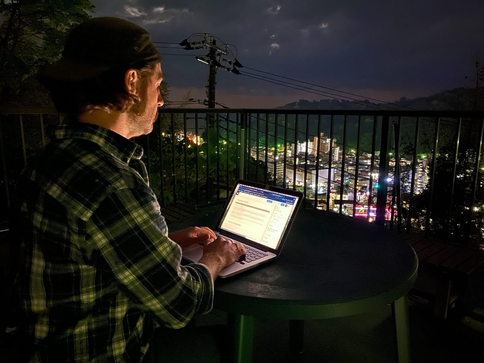 Matt Ketchum of Akiyaz working on a computer above Yugawara in Kanagawa, Japan.