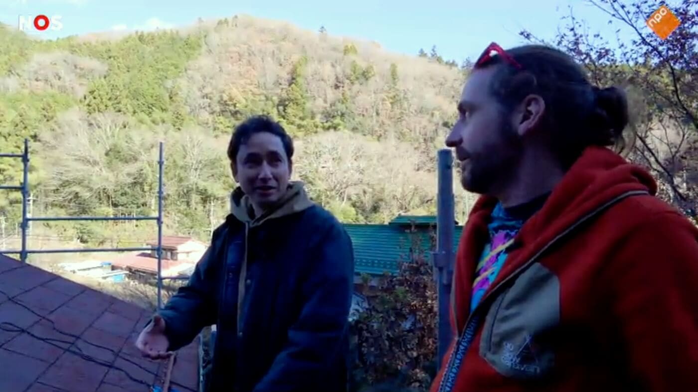 Matt Ketchum of Akiyaz and Anoma van der Veere of The Netherlands' NOS broadcasting inspecting the roof of an akiya in Kanagawa, Japan